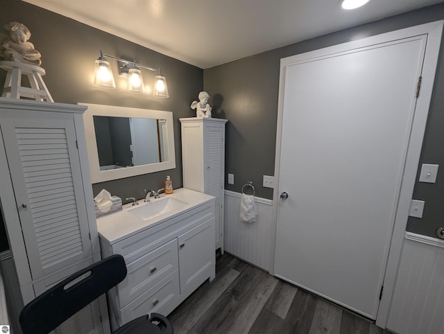 bathroom featuring wainscoting, vanity, and wood finished floors