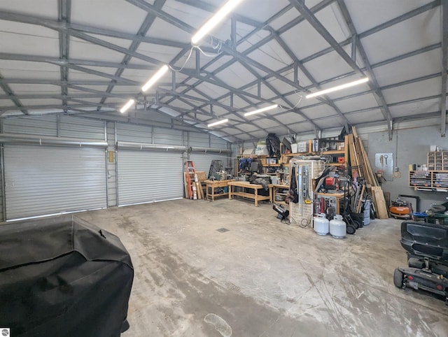 garage with a workshop area and metal wall