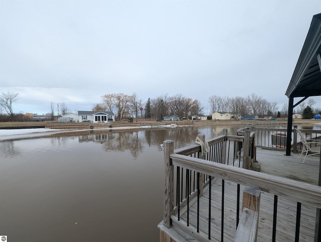 dock area featuring a deck with water view