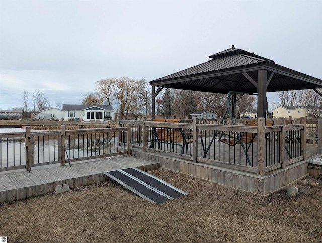 wooden terrace featuring a gazebo and a residential view