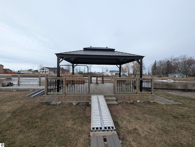 view of dock featuring a gazebo, a yard, and fence