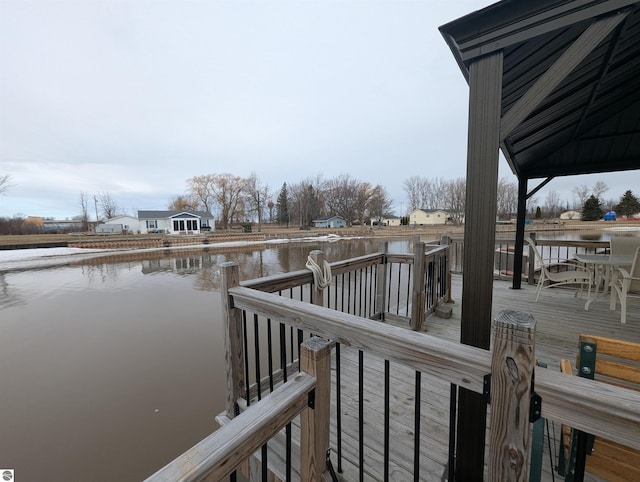 dock area featuring a deck with water view