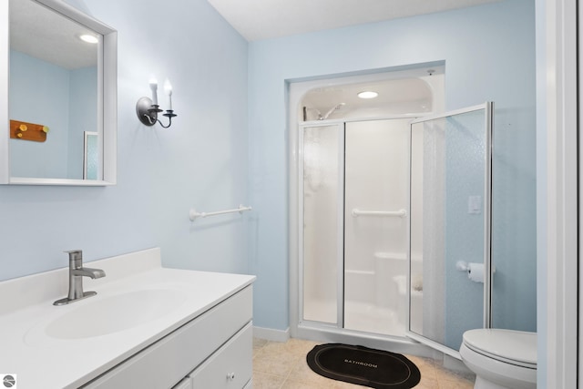 full bathroom with tile patterned flooring, baseboards, toilet, a stall shower, and vanity