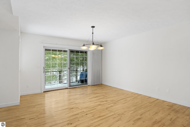 empty room featuring light wood-style floors and baseboards