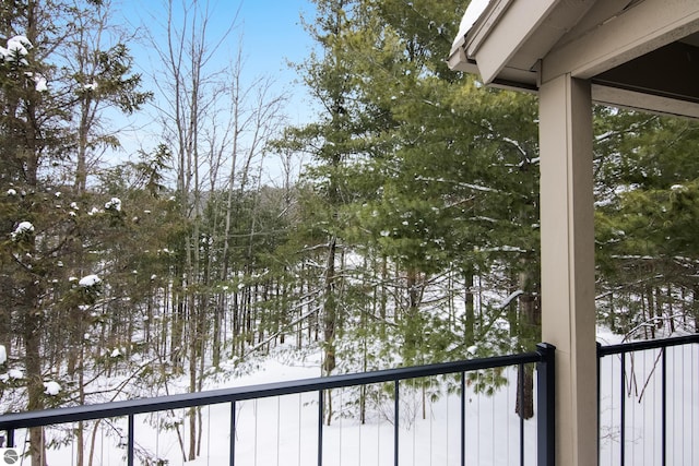 view of snow covered back of property