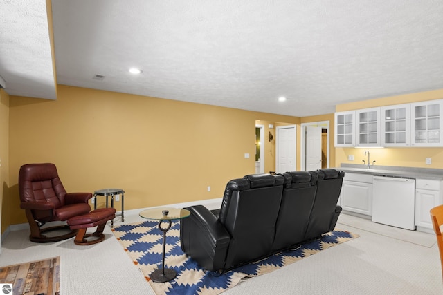 living room featuring recessed lighting, baseboards, and light carpet