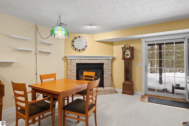 carpeted dining area featuring a fireplace, a textured ceiling, and baseboards