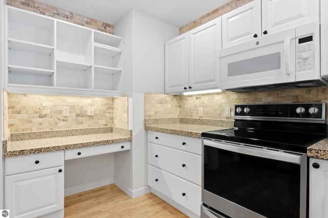 kitchen featuring open shelves, white cabinetry, stainless steel electric range oven, white microwave, and built in study area