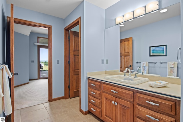 bathroom with tile patterned flooring, vanity, and baseboards