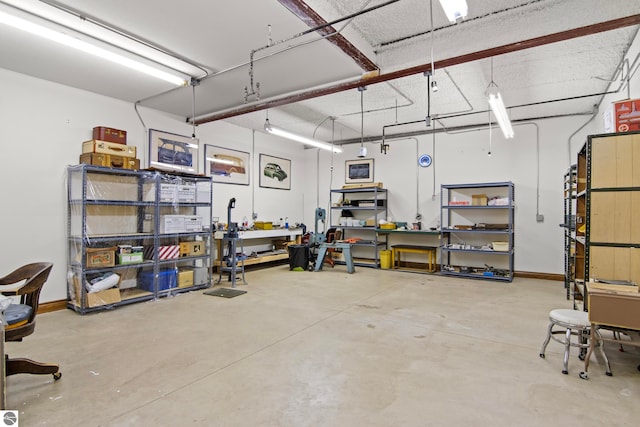 garage with a workshop area and baseboards