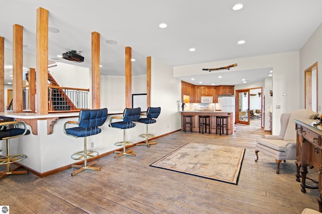 interior space with light wood finished floors, recessed lighting, and baseboards