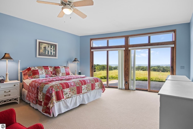 carpeted bedroom with access to exterior and ceiling fan