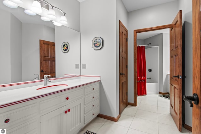 bathroom with tile patterned floors, vanity, baseboards, and shower / bathtub combination with curtain