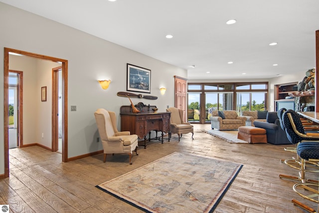 living area featuring recessed lighting, light wood-type flooring, and baseboards