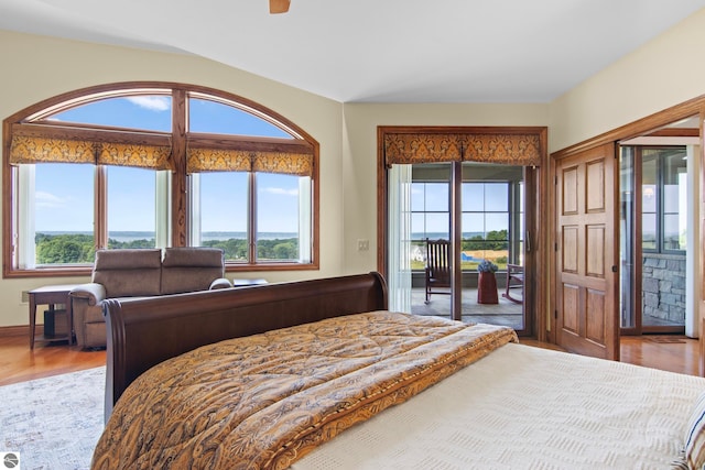 bedroom featuring access to exterior and wood finished floors