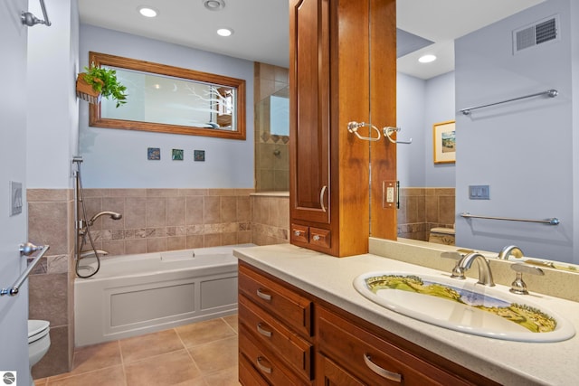 bathroom featuring tile patterned floors, visible vents, toilet, a bath, and vanity