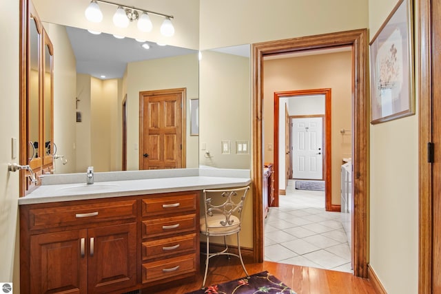 bathroom with vanity, tile patterned floors, and baseboards