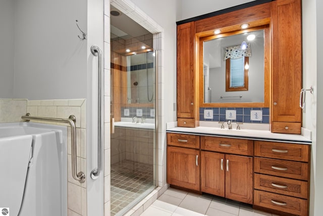 full bath with vanity, a shower stall, and tile patterned floors