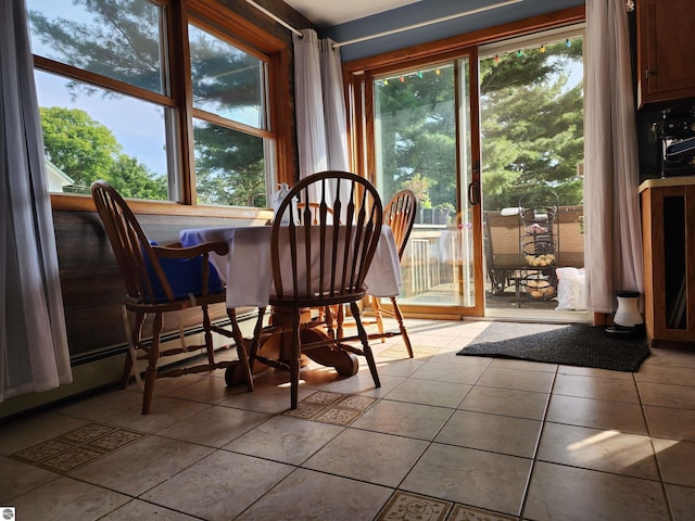 dining space featuring a wealth of natural light and light tile patterned flooring