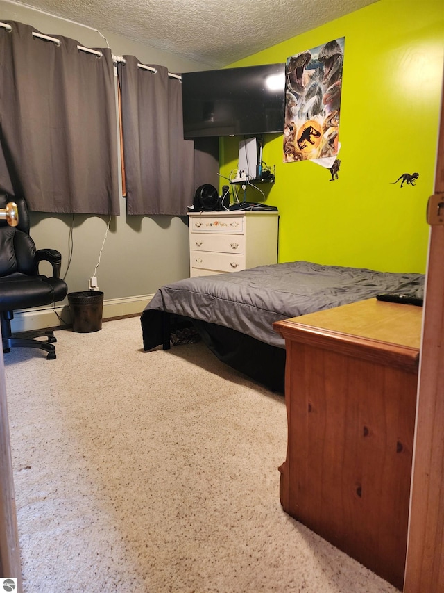 bedroom with a baseboard radiator and a textured ceiling