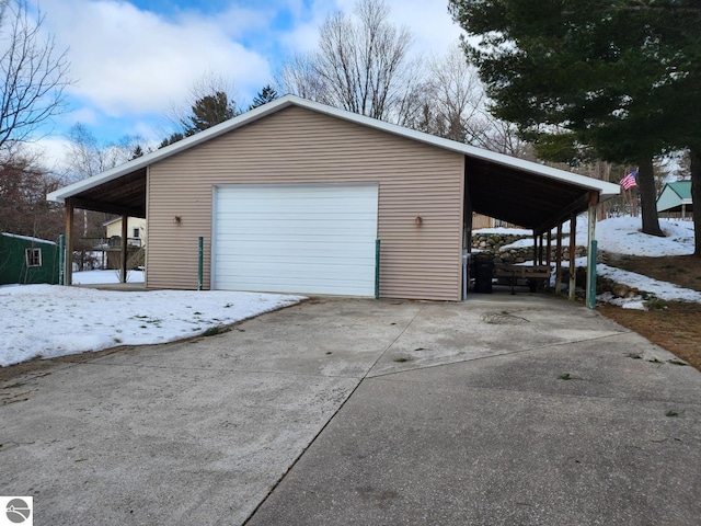 garage with a detached garage and driveway