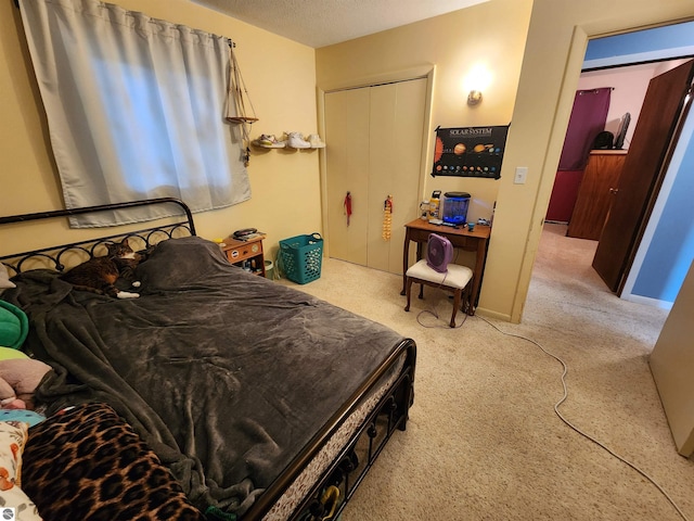 bedroom featuring a textured ceiling, baseboards, and carpet floors