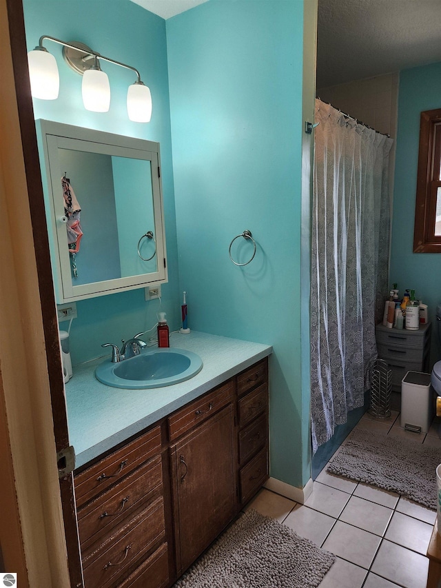 bathroom with tile patterned floors, curtained shower, and vanity