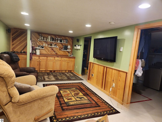 living room featuring recessed lighting, a wainscoted wall, and wood walls