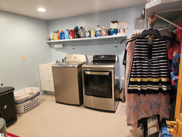 washroom with washer and dryer, cabinet space, and recessed lighting