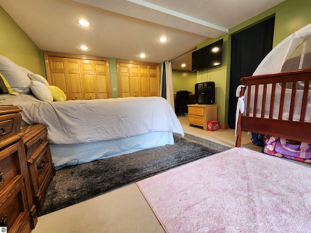 bedroom featuring recessed lighting and two closets