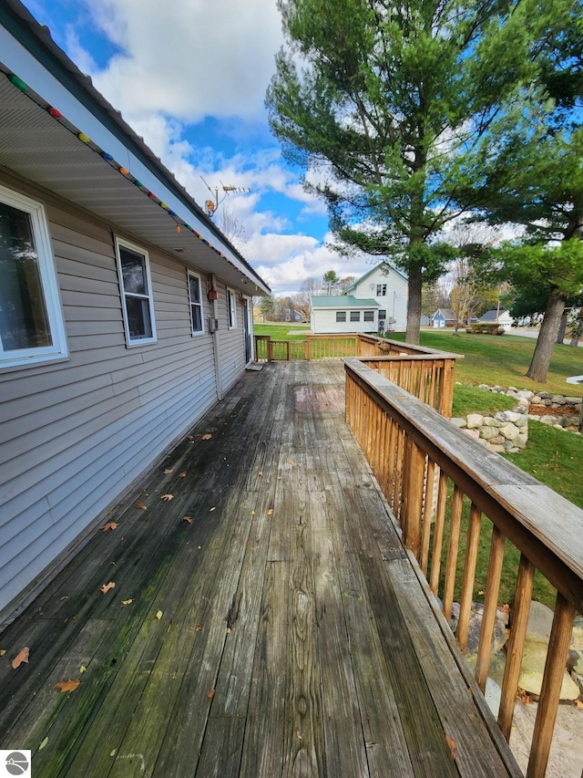 wooden terrace featuring a yard