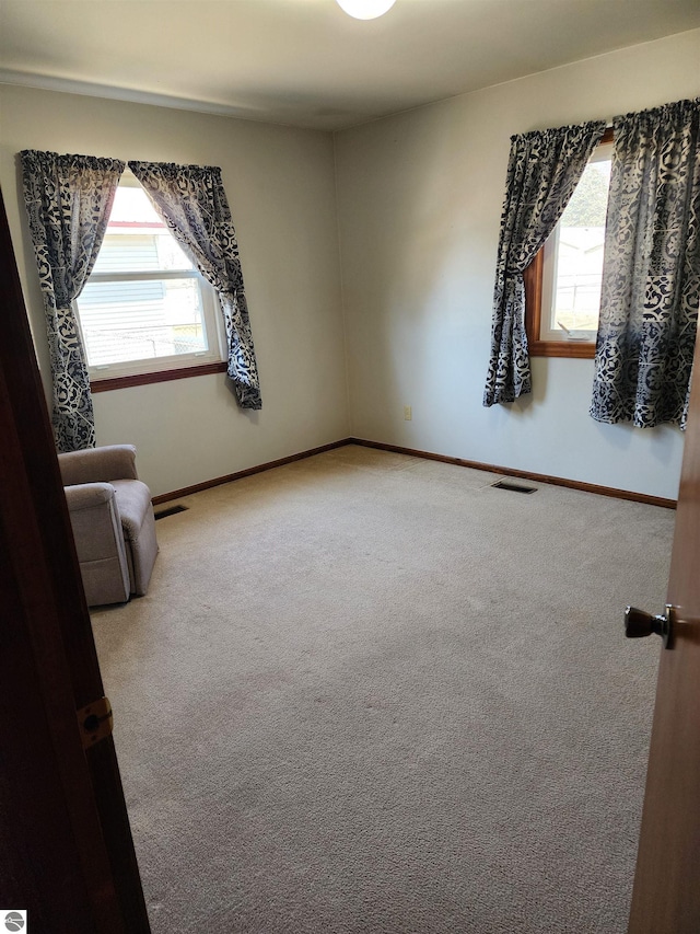 interior space featuring visible vents, baseboards, and a healthy amount of sunlight