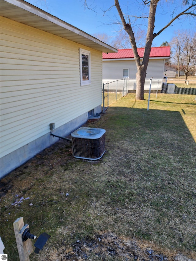 view of yard featuring cooling unit and fence