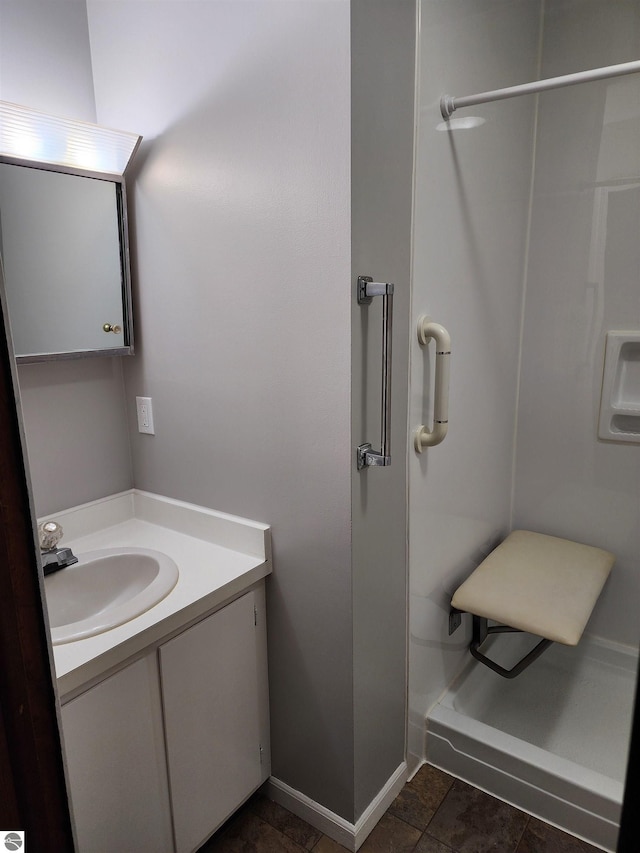 full bathroom featuring vanity and walk in shower