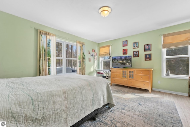 bedroom with wood finished floors and baseboards