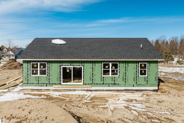 exterior space featuring a shingled roof