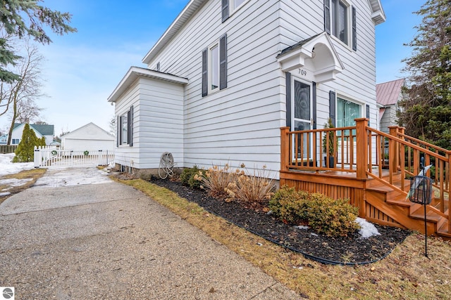 view of side of home with a gate and fence