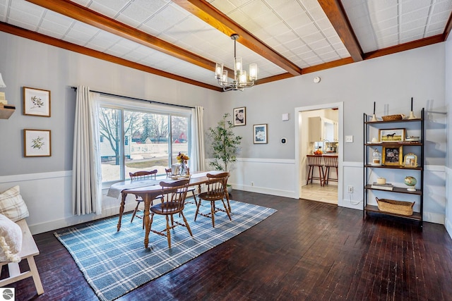 dining room with baseboards, wood-type flooring, beam ceiling, and a chandelier