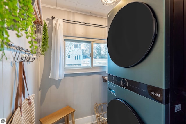 clothes washing area featuring laundry area and stacked washer / drying machine