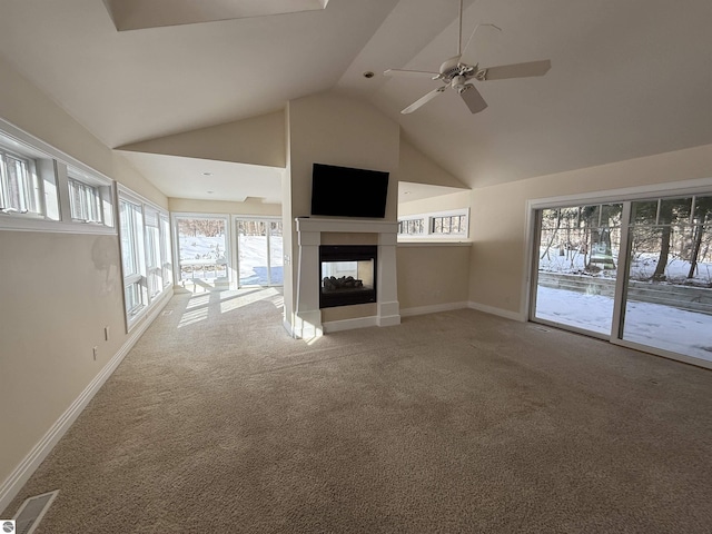 unfurnished living room featuring a multi sided fireplace, carpet flooring, high vaulted ceiling, and baseboards