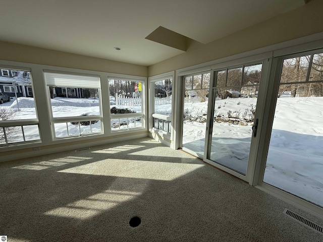 unfurnished sunroom featuring visible vents and plenty of natural light