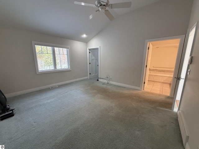 unfurnished bedroom featuring visible vents, baseboards, high vaulted ceiling, and carpet flooring