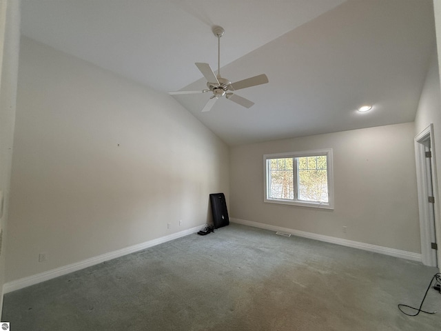 carpeted empty room featuring visible vents, ceiling fan, baseboards, and vaulted ceiling