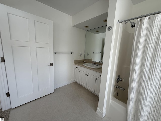 full bathroom featuring baseboards, shower / bath combo with shower curtain, and vanity