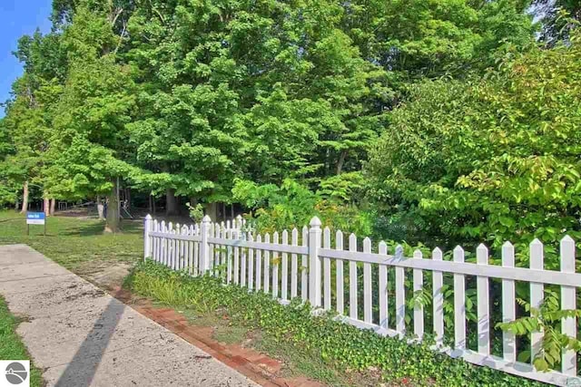 exterior space featuring fence and a lawn