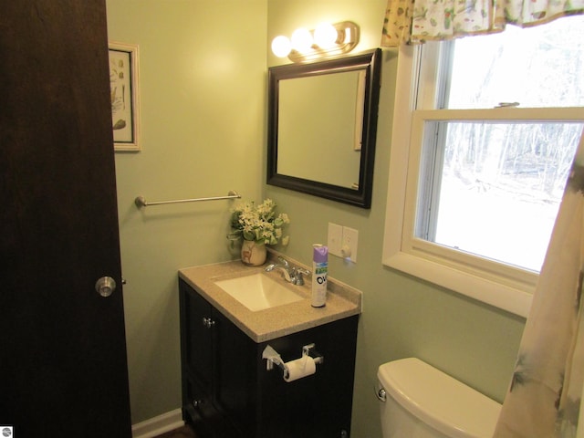 half bath featuring toilet and vanity