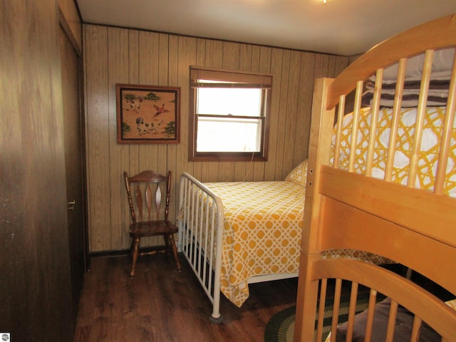 bedroom with wooden walls and wood finished floors