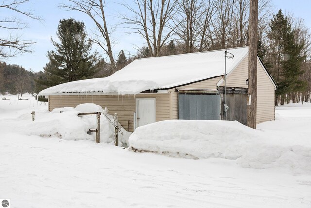 snow covered garage with a garage
