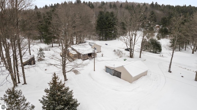snowy aerial view featuring a view of trees
