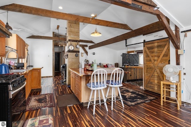 kitchen with a barn door, vaulted ceiling with beams, dark wood-type flooring, and gas range